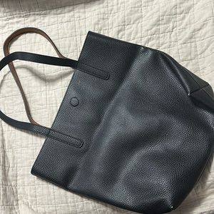 Reversible black and brown imitation leather tote.